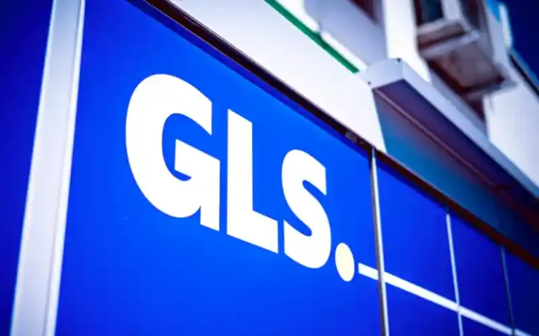 Blue storefront with and white GLS logo on a blue panel façade.